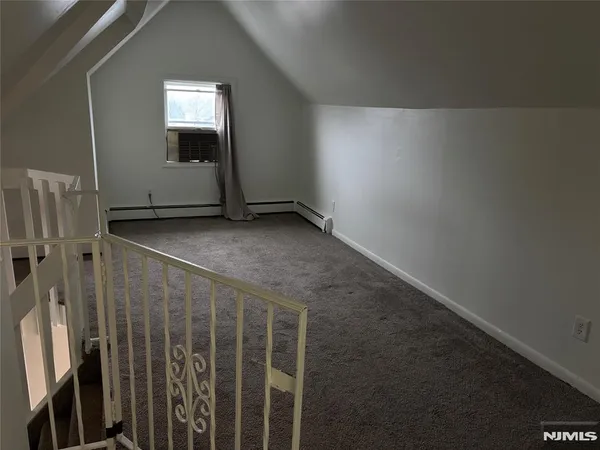 a view of staircase with railing and a window