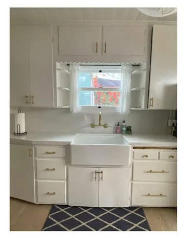 a kitchen with cabinets appliances and a sink