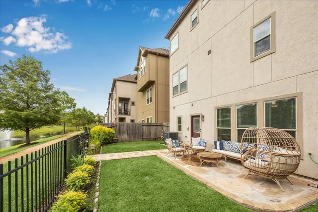 a view of a house with backyard and sitting area