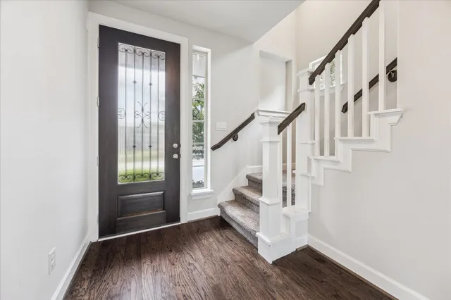 a view of entryway with wooden floor and stairs