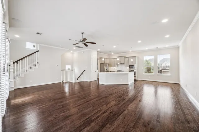 a view of a kitchen with wooden floors and a kitchen view