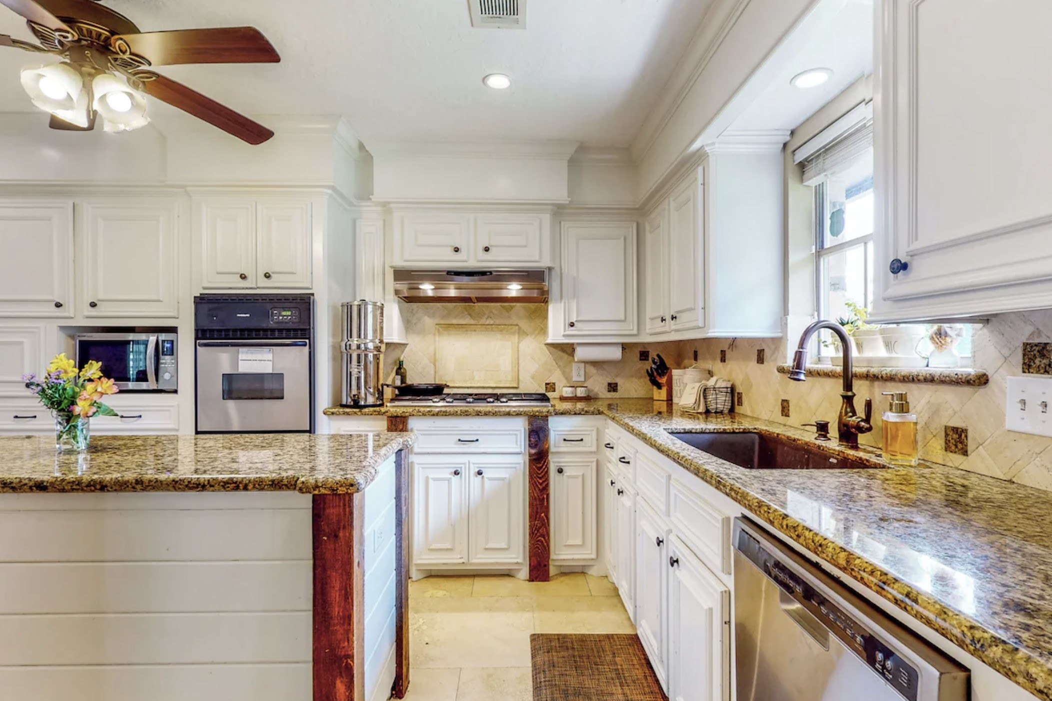 30819 Quinn Road Tomball, TX 77375 - Photo 5 of 30 a kitchen with stainless steel appliances granite countertop a sink a stove and cabinets