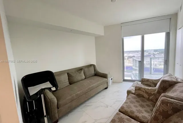 a living room with furniture and a large window