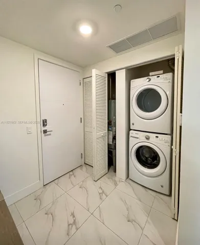 a view of a hallway with washer and dryer