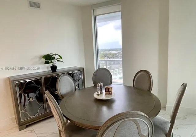 a view of a dining room with furniture and window