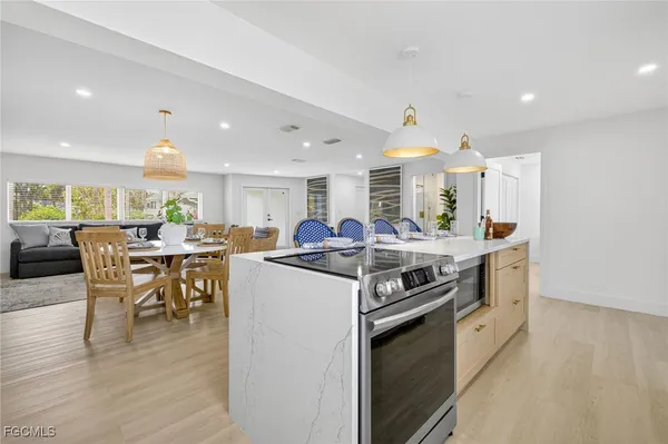 a kitchen with stainless steel appliances granite countertop a stove and a refrigerator