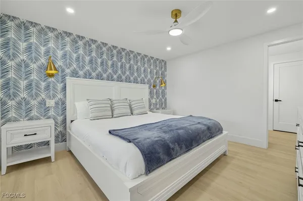a bedroom with a bed and a night stand