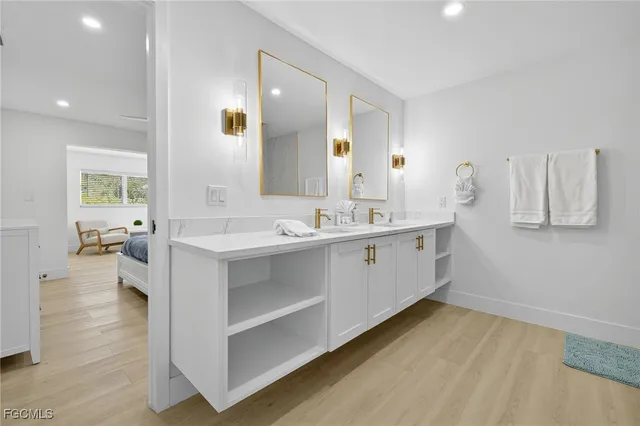 a bathroom with a sink mirror vanity and toilet