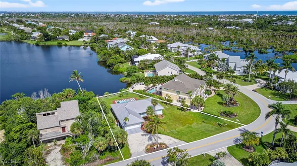 an aerial view of residential houses with outdoor space and river