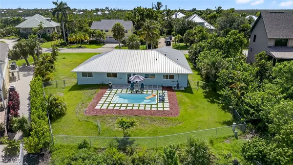 an aerial view of a house having swimming pool patio and outdoor seating