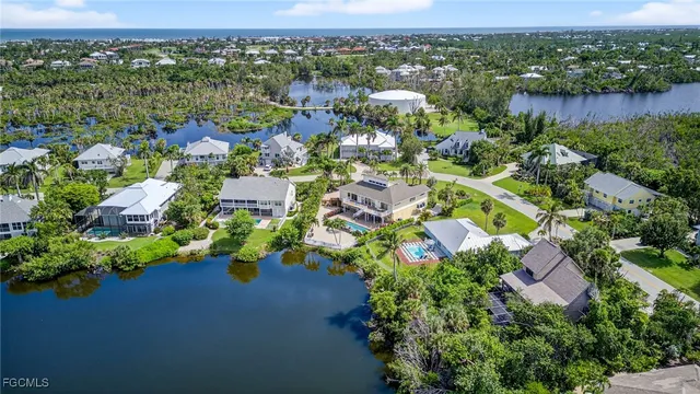 an aerial view of lake and residential houses with outdoor space