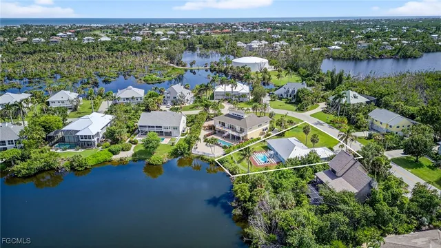 an aerial view of residential house with outdoor space and lake view