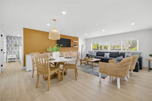 a view of a dining room with furniture and wooden floor