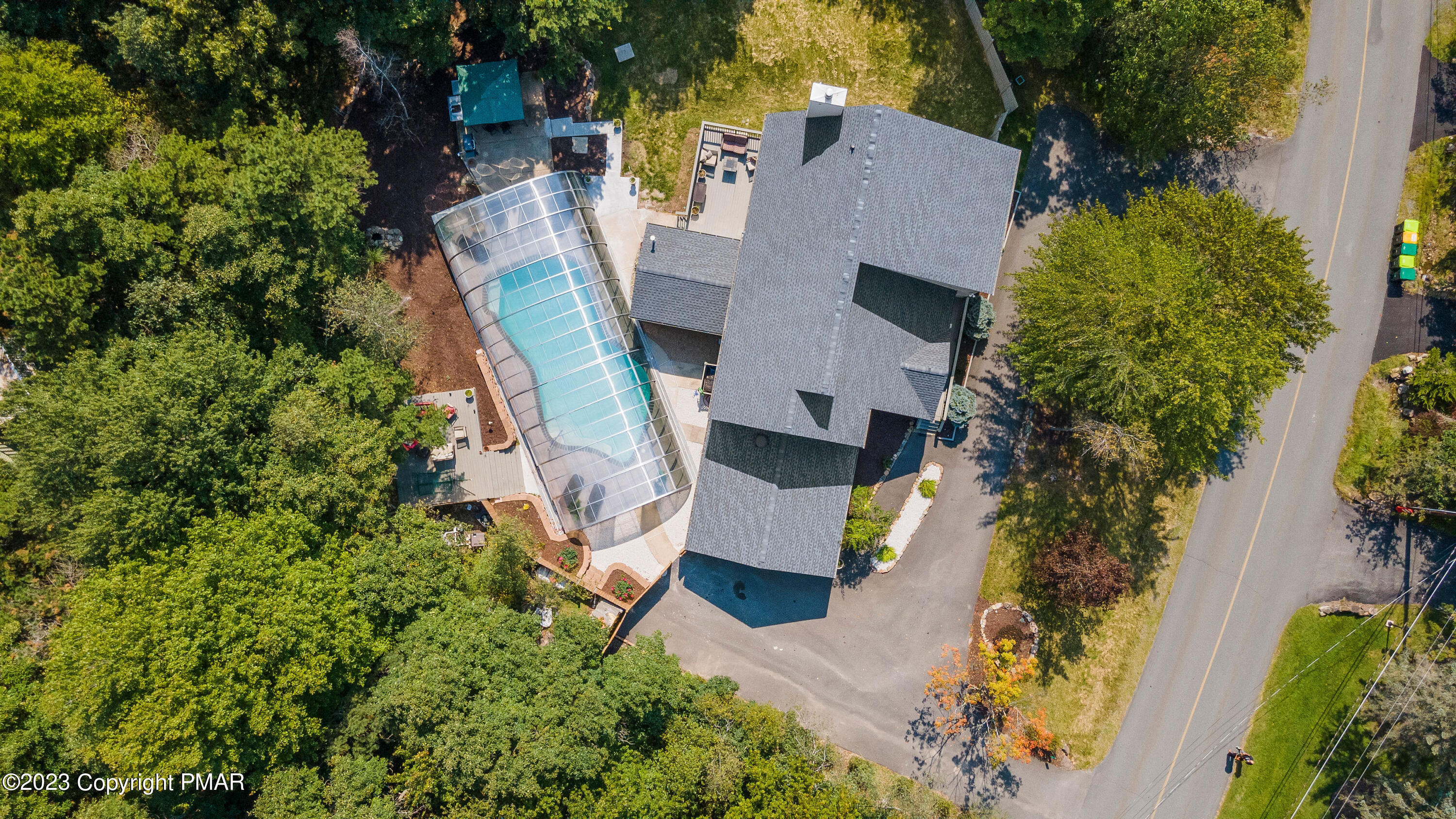 an aerial view of a house with a yard and garden