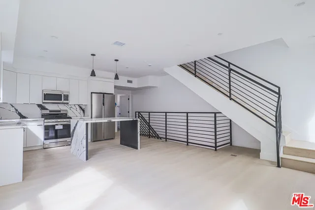 a view of kitchen with cabinets and microwave