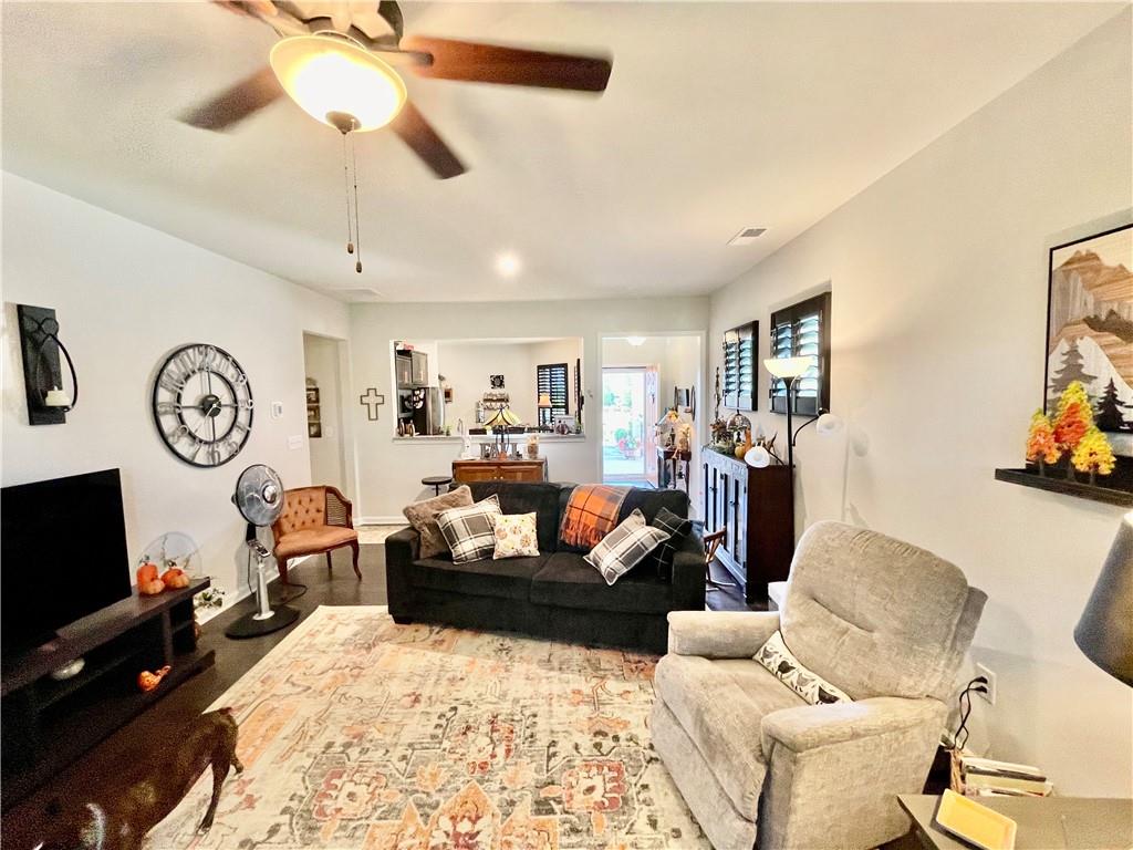5709 Grapewood Street Hoschton, GA 30548 - Photo 11 of 65 a living room with furniture kitchen view and a flat screen tv