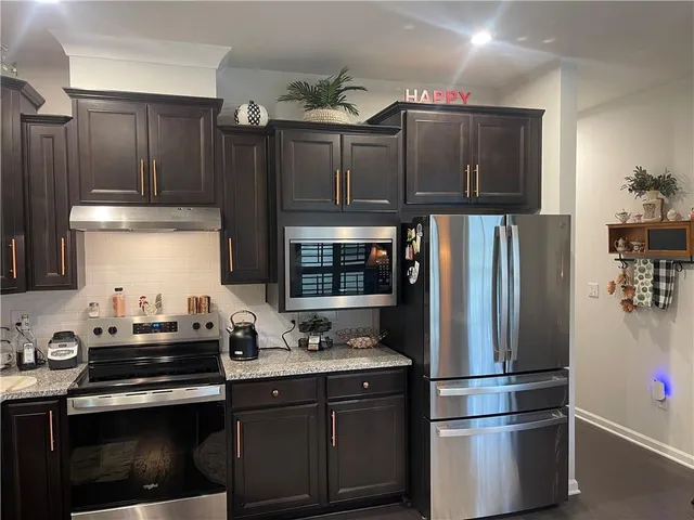 a bedroom with a bed window and a flat screen tv
