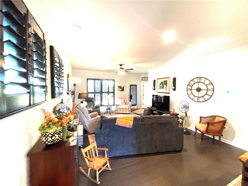 5709 Grapewood Street Hoschton, GA 30548 - Photo 24 of 65 a living room with furniture and a large window