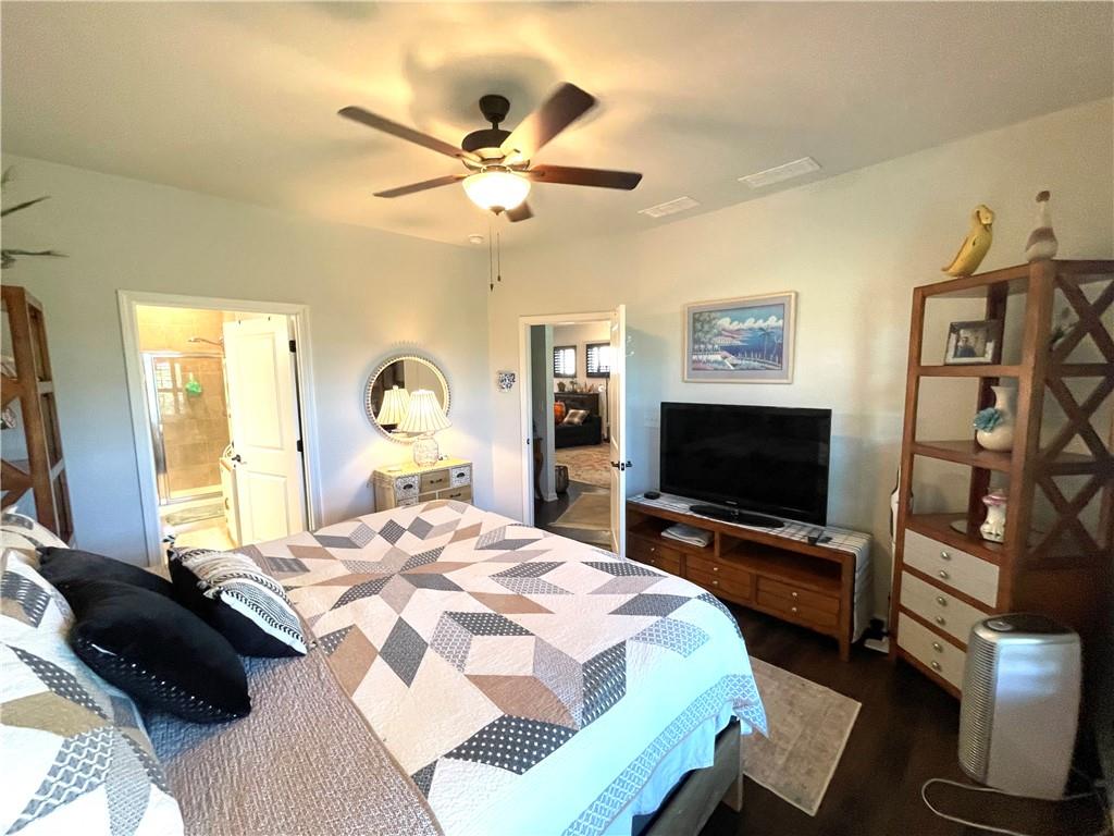5709 Grapewood Street Hoschton, GA 30548 - Photo 28 of 65 a bedroom with a bed window and a flat screen tv
