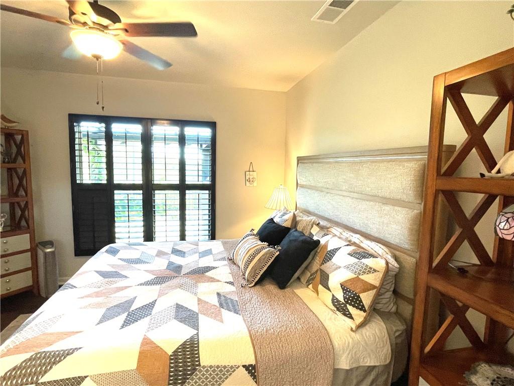 5709 Grapewood Street Hoschton, GA 30548 - Photo 30 of 65 a bed sitting in a bedroom next to a window