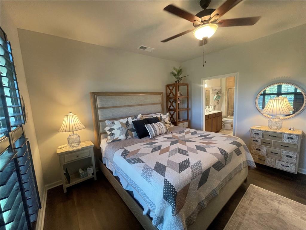 5709 Grapewood Street Hoschton, GA 30548 - Photo 34 of 65 a bedroom with bed and a chandelier