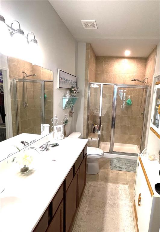 5709 Grapewood Street Hoschton, GA 30548 - Photo 36 of 65 a bathroom with a double vanity sink and a mirror