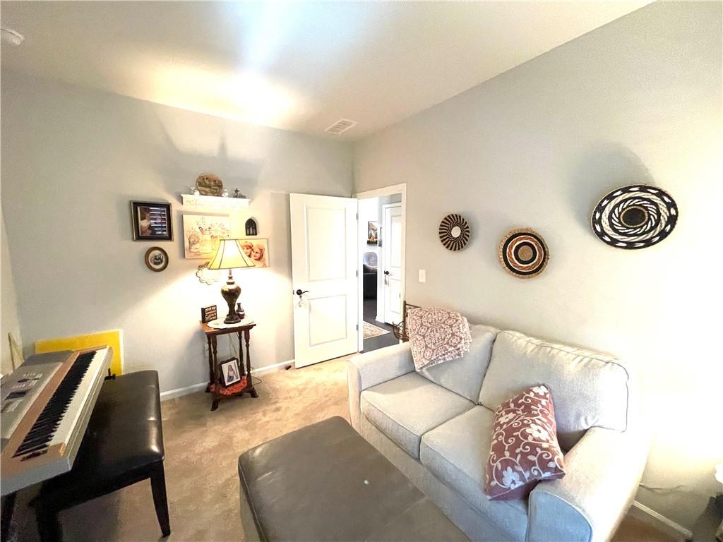 5709 Grapewood Street Hoschton, GA 30548 - Photo 40 of 65 a living room with furniture and a couch