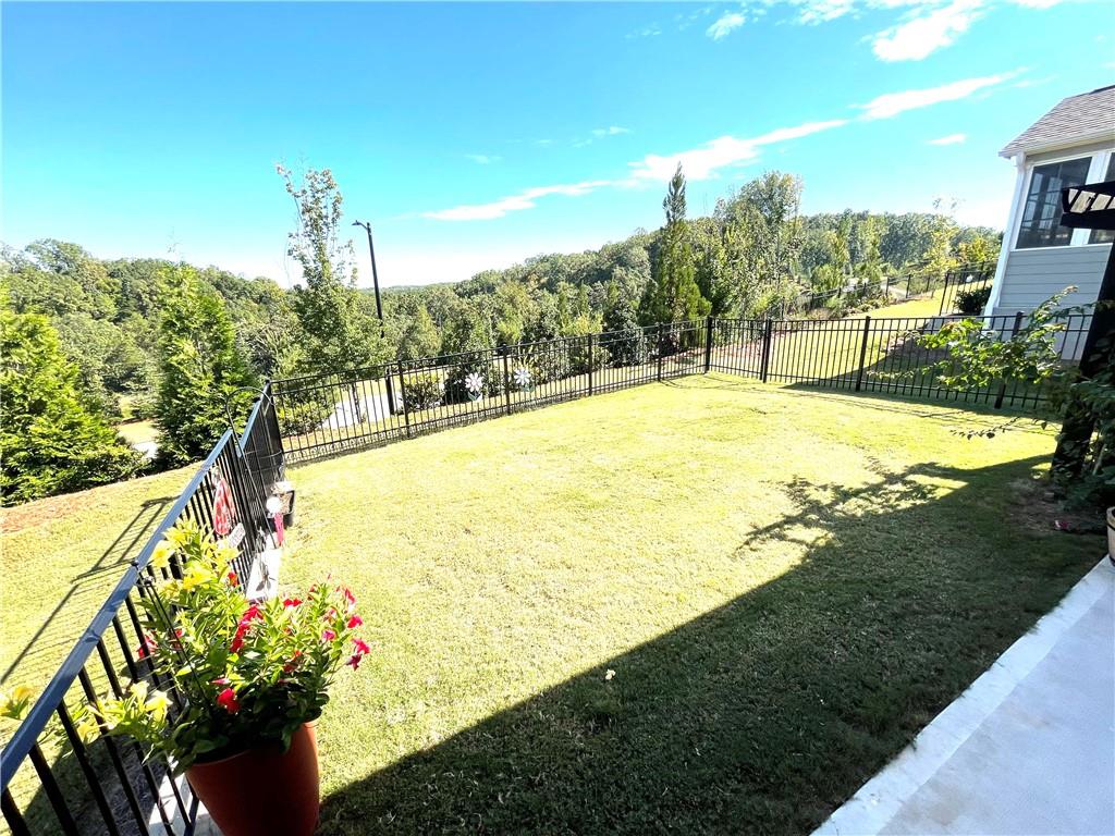 5709 Grapewood Street Hoschton, GA 30548 - Photo 46 of 65 a view of a yard with an outdoor space