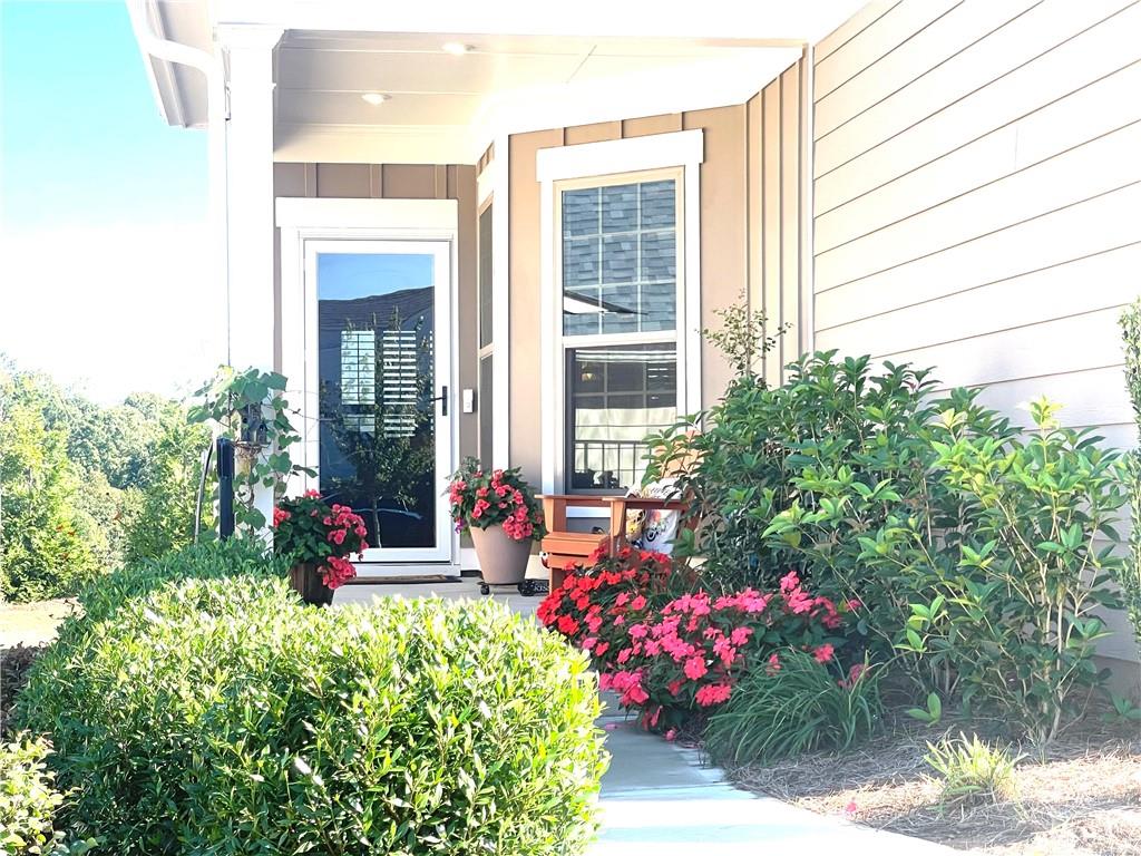 5709 Grapewood Street Hoschton, GA 30548 - Photo 5 of 65 a view of a house with a backyard and garden