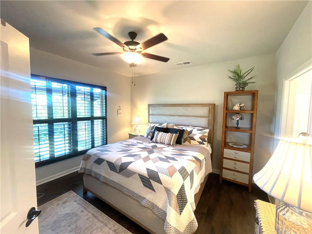 5709 Grapewood Street Hoschton, GA 30548 - Photo 56 of 65 a bedroom with a large bed and a window