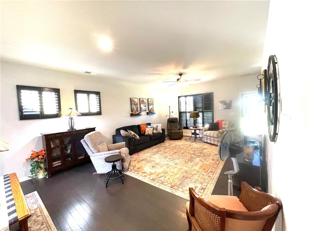 5709 Grapewood Street Hoschton, GA 30548 - Photo 64 of 65 a living room with furniture window and a flat screen tv