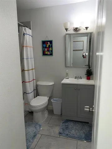 a bedroom with a bed and a television