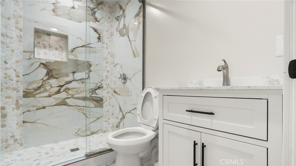 19928 Hatton Street Winnetka, CA 91306 - Photo 14 of 15 a bathroom with a sink and mirror