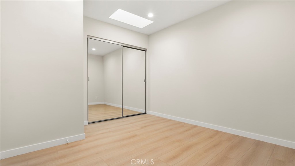 19928 Hatton Street Winnetka, CA 91306 - Photo 8 of 15 an empty room with wooden floor and closet