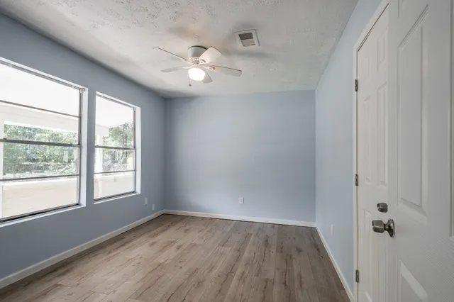 wooden floor in an empty room with a window