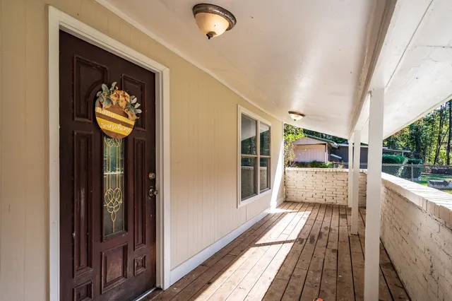 a view of a balcony with wooden floor and iron stairs