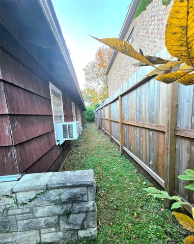 a view of wooden house with a backyard