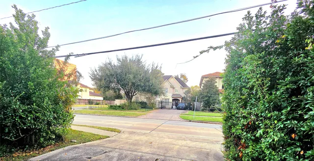 a view of a building with a yard and fountain in the middle