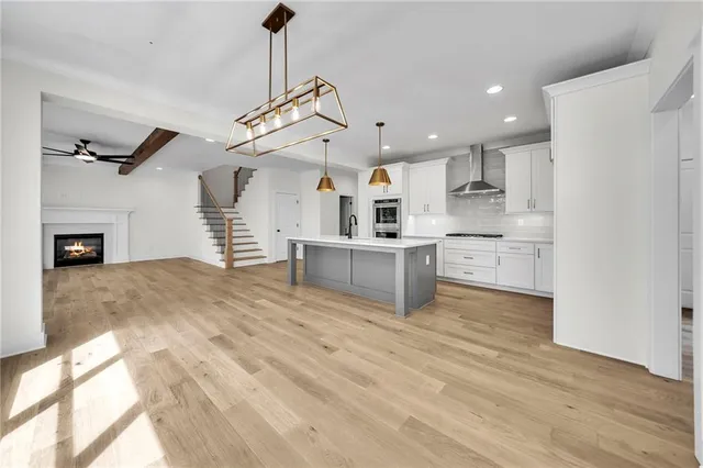 a view of a livingroom with wooden floor and stairs