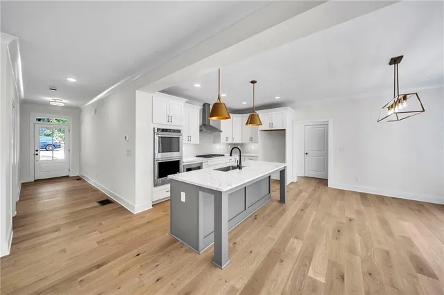 a kitchen with stainless steel appliances granite countertop a stove and a sink