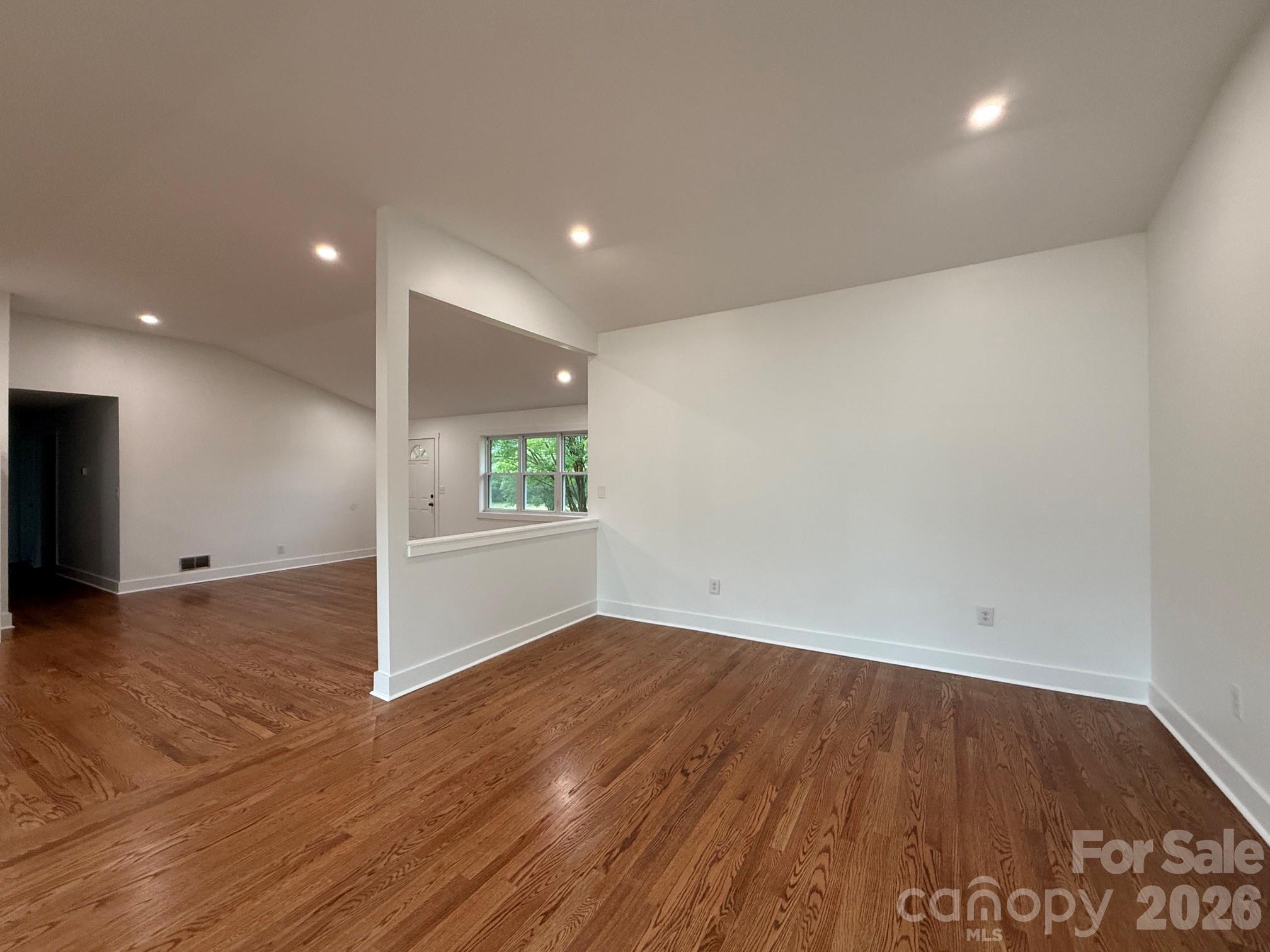 2677 Pax Hill Road Morganton, NC 28655 - Photo 4 of 15 an empty room with wooden floor and windows