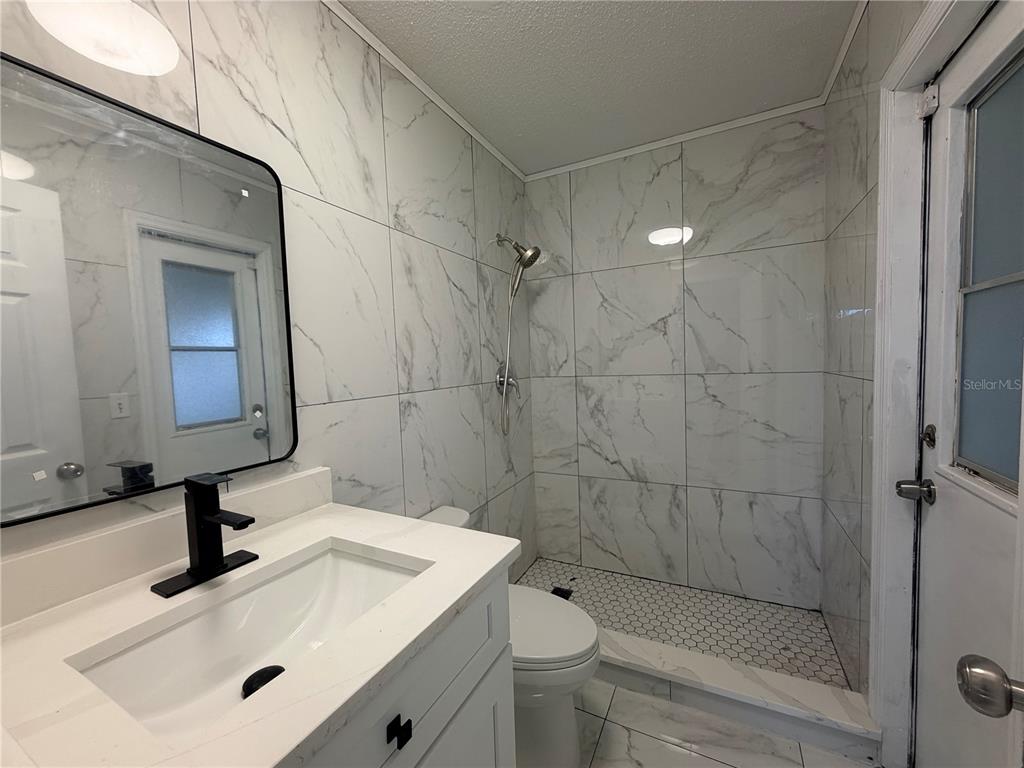 1365 Alton Road Port Charlotte, FL 33952 - Photo 11 of 13 a bathroom with a sink a toilet and shower