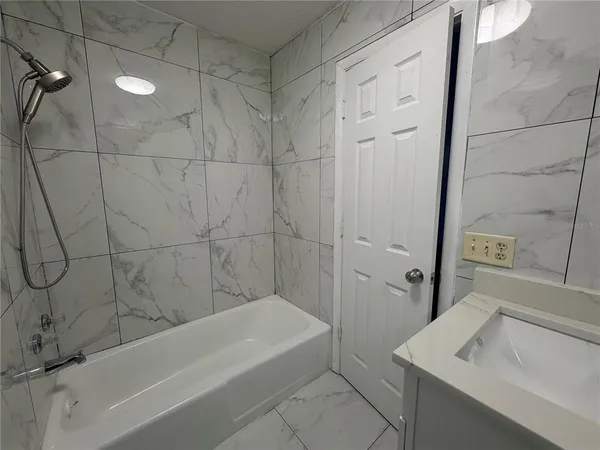 a bathroom with a sink and a bathtub