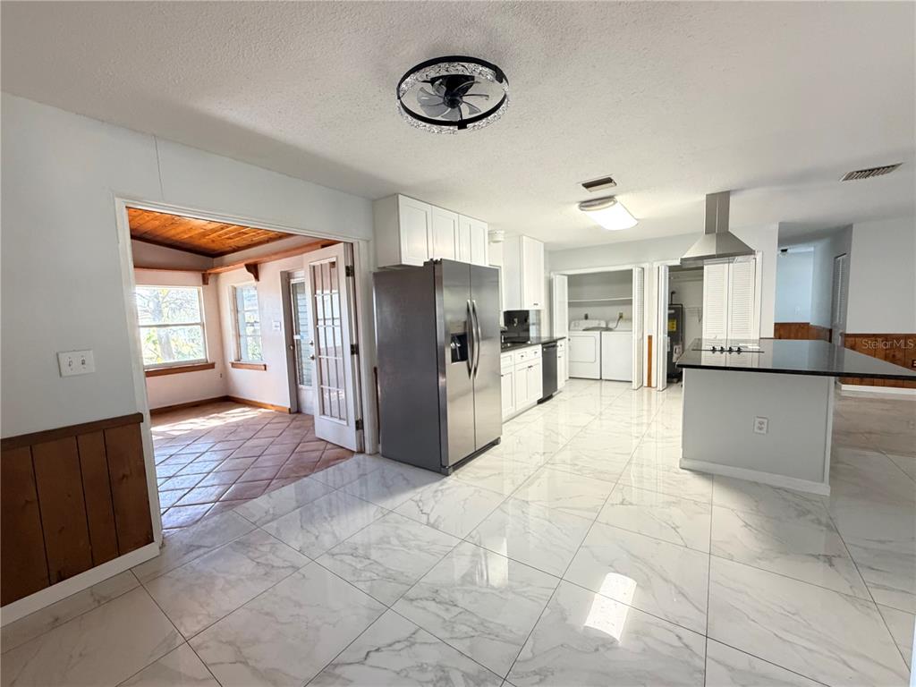 1365 Alton Road Port Charlotte, FL 33952 - Photo 4 of 13 a view of a kitchen with refrigerator and window