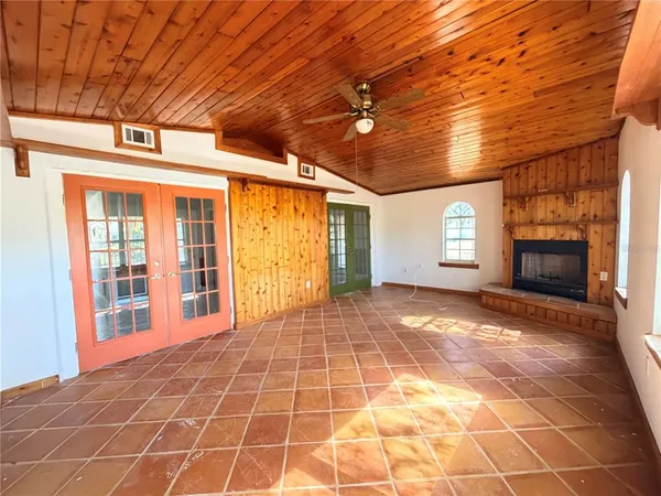 a view of a livingroom with a window and fireplace