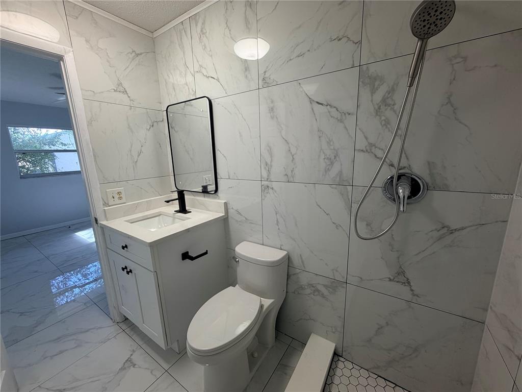 1365 Alton Road Port Charlotte, FL 33952 - Photo 10 of 13 a bathroom with a toilet sink and mirror