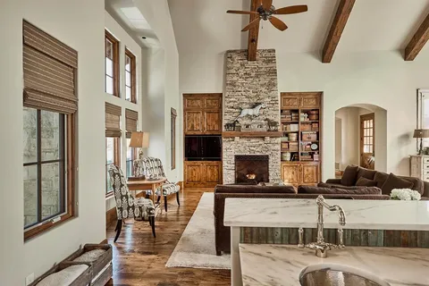 a living room with fireplace furniture and a flat screen tv