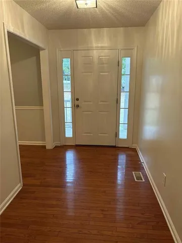a view of a room with wooden floor