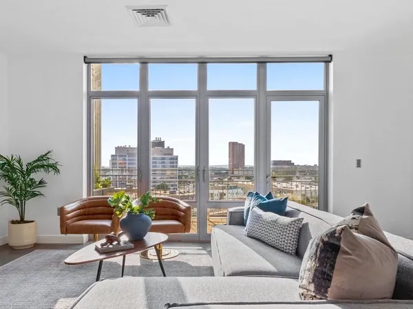 a living room with furniture and a large window