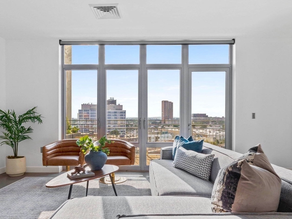 a living room with furniture and a large window
